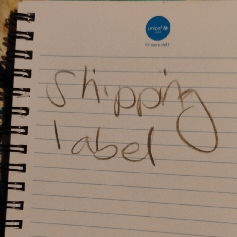 White and Blue Spiral-Bound Notebook with Handwritten Style